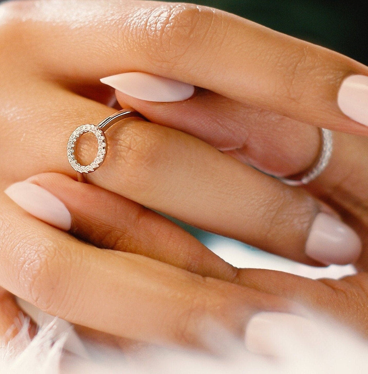 Dainty sterling silver circle stacking ring worn on the finger