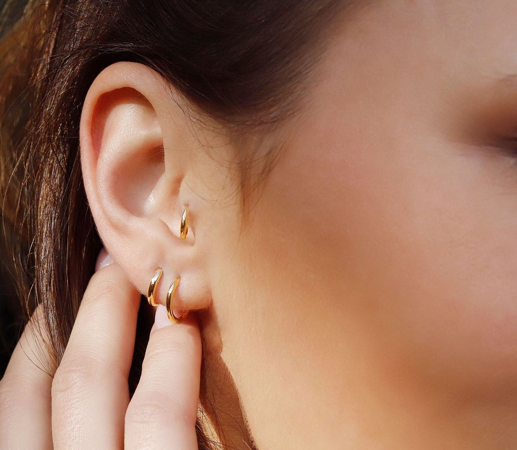 Sterling silver huggie hoop earrings by AJJ, minimalist open geometric silver hoops with a delicate, simple design.