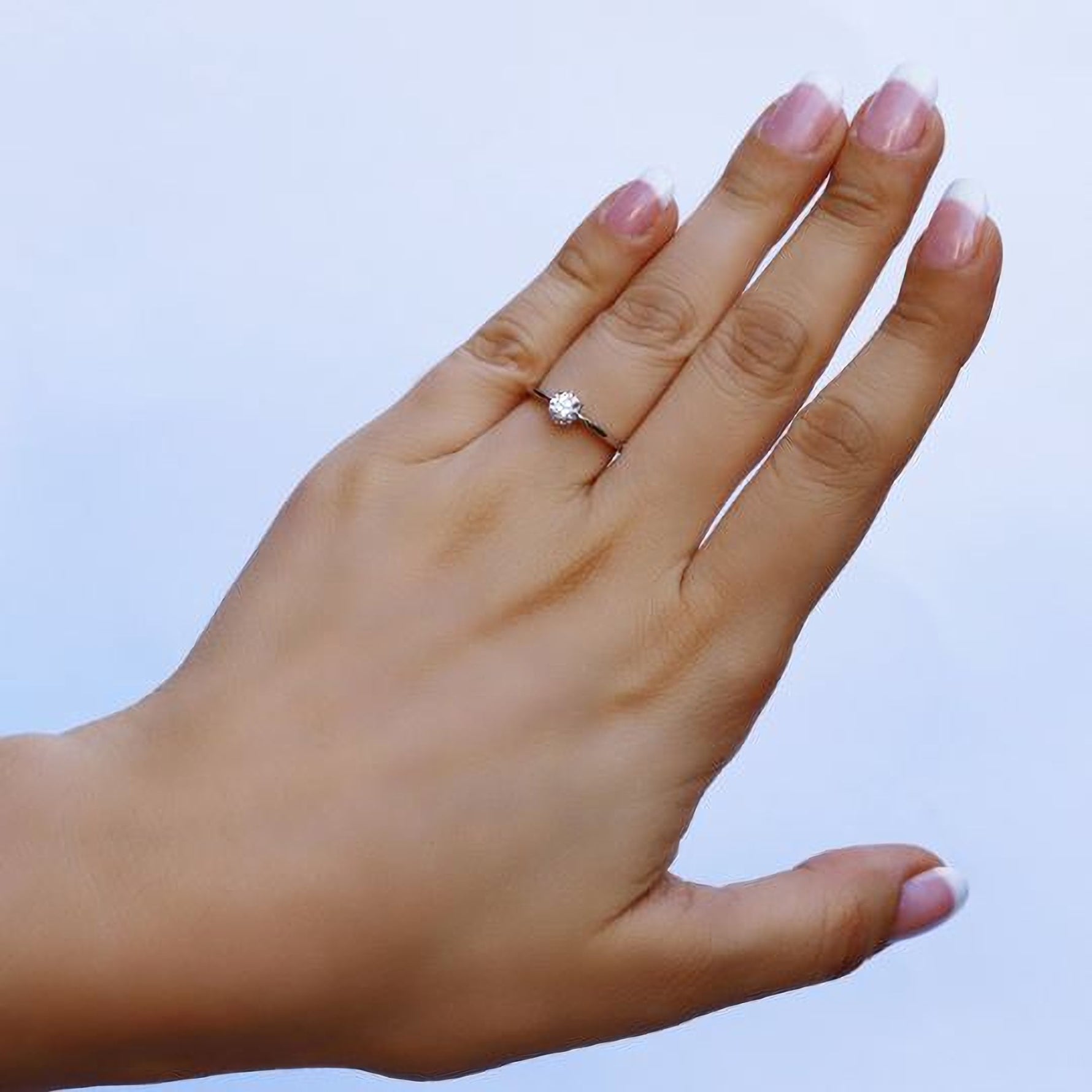 Sterling silver bridal engagement ring by AJJ featuring a delicate promise ring design for women, available in US and UK sizes.