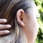 AJJ tiny huggie hoop earrings featuring dainty plain helix design, close-up of small, minimalist gold hoop earrings for everyday wear