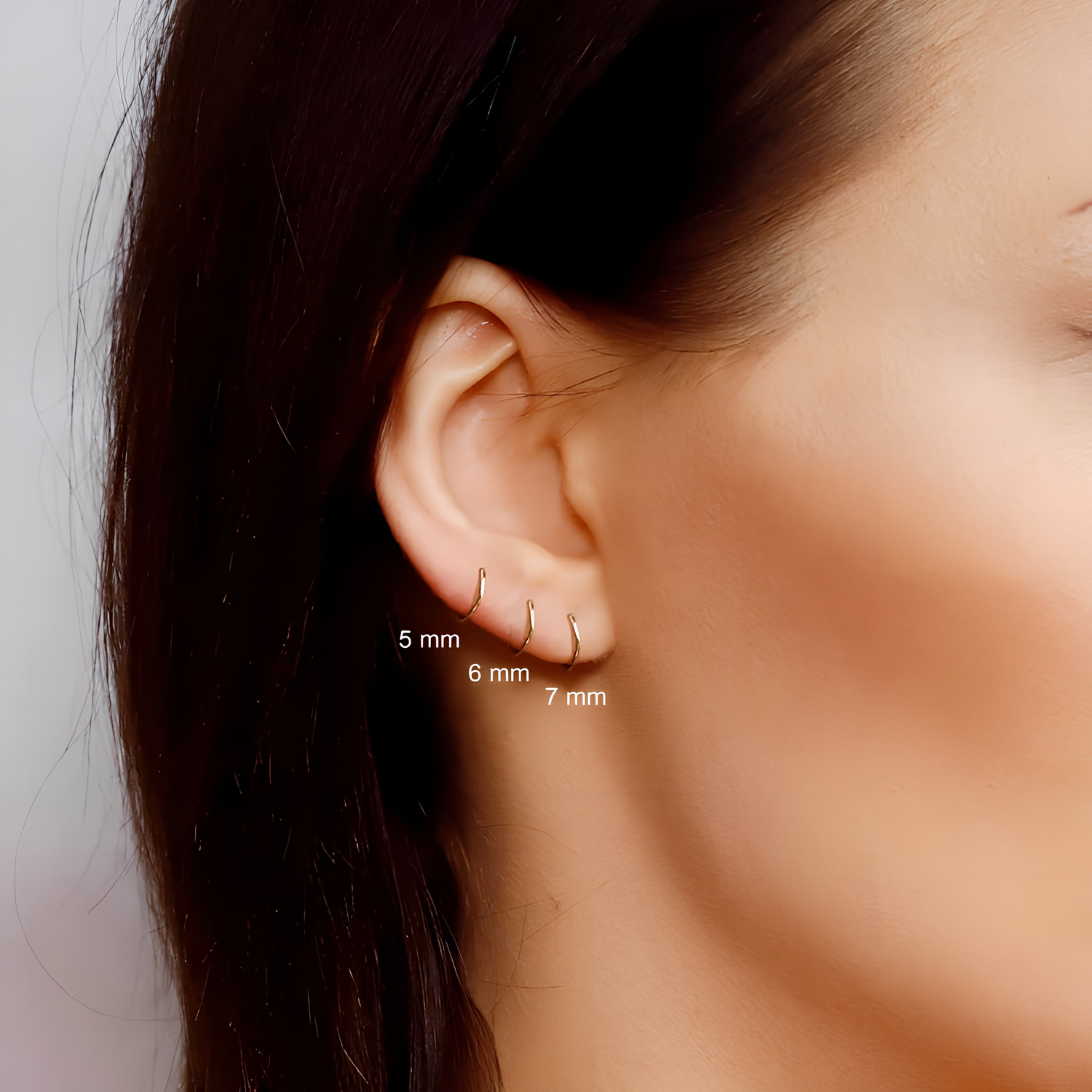AJJ Tiny huggie hoop earrings, plain helix design, dainty gold hoop earrings suitable for everyday wear.