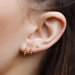 Sterling silver huggie hoop earrings with delicate bead detail, minimalist design, by AJJ, shown in full view on a white background.