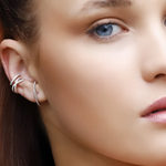 Close-up of AJJ Naomi tiny gold ear cuff with conch and huggie cz design, showcasing dainty curved bar and polished finish.