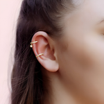 AJJ gold and silver Huggie Hoop Earrings featuring conch, cartilage, tragus, and helix hoops with pave ring detailing.