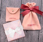 Amber James Jewellery LDT gift wrap packaging with elegant wrapping paper and ribbon for jewelry presentation.