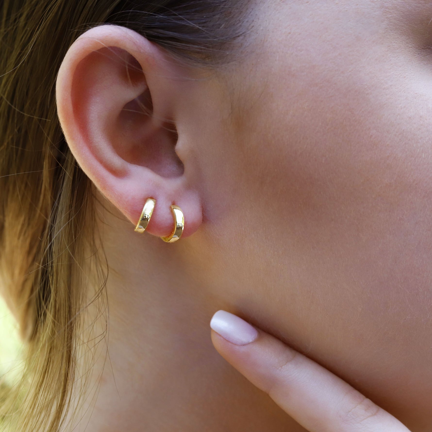 Rose gold plated sterling silver tiny huggie hoop earrings with a sleek square edge design, perfect for delicate, everyday wear.