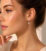 A close-up of a woman's face, focusing on her earrings and chin.