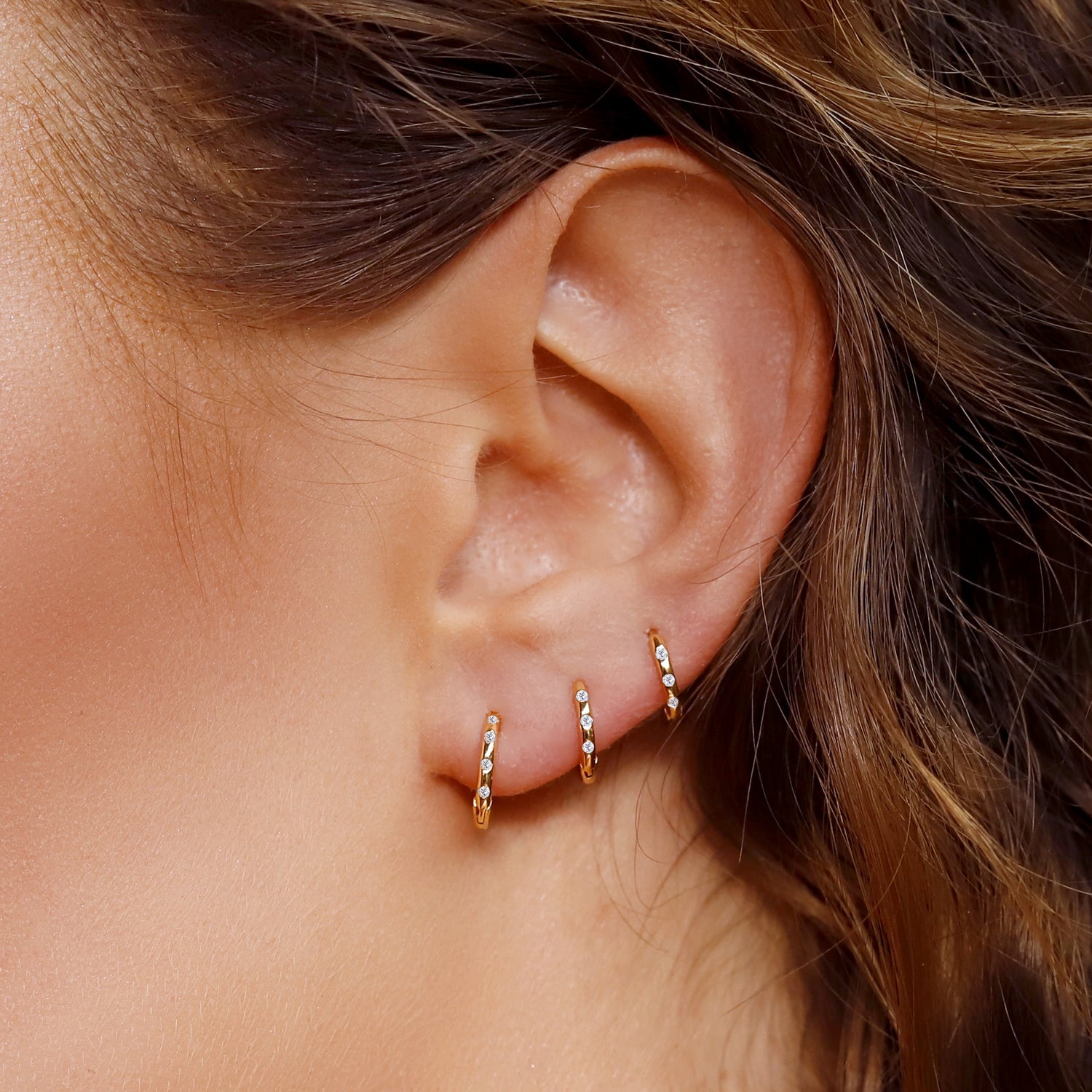 Sterling silver Aurora huggie hoop earrings by AJJ, delicate minimalist jewelry, showcasing sleek, small hoop design for everyday wear.