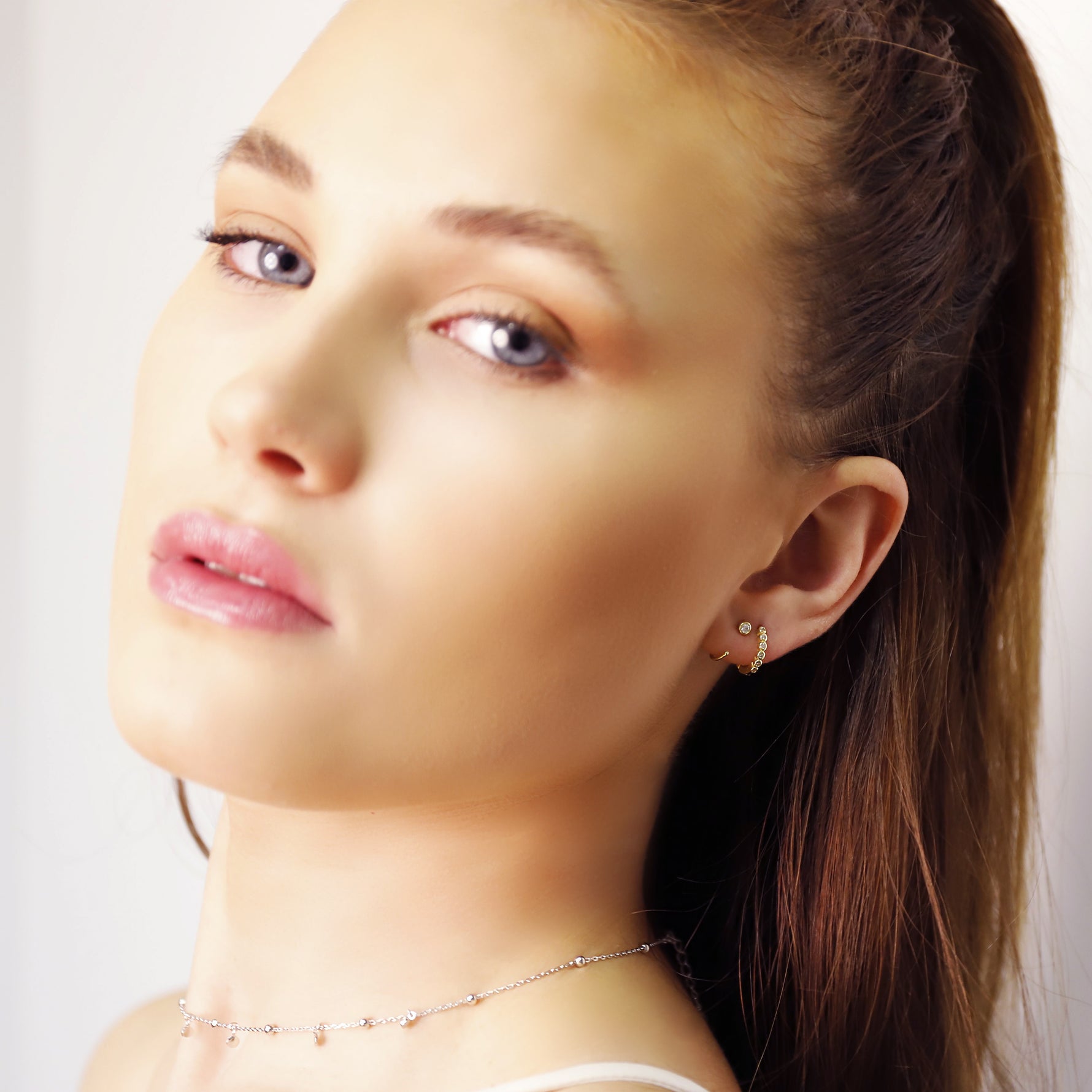 AJJ Shelly Classic Huggie Hoops with 8mm CZ stones in yellow gold sterling silver 925, featuring simple pave design.
