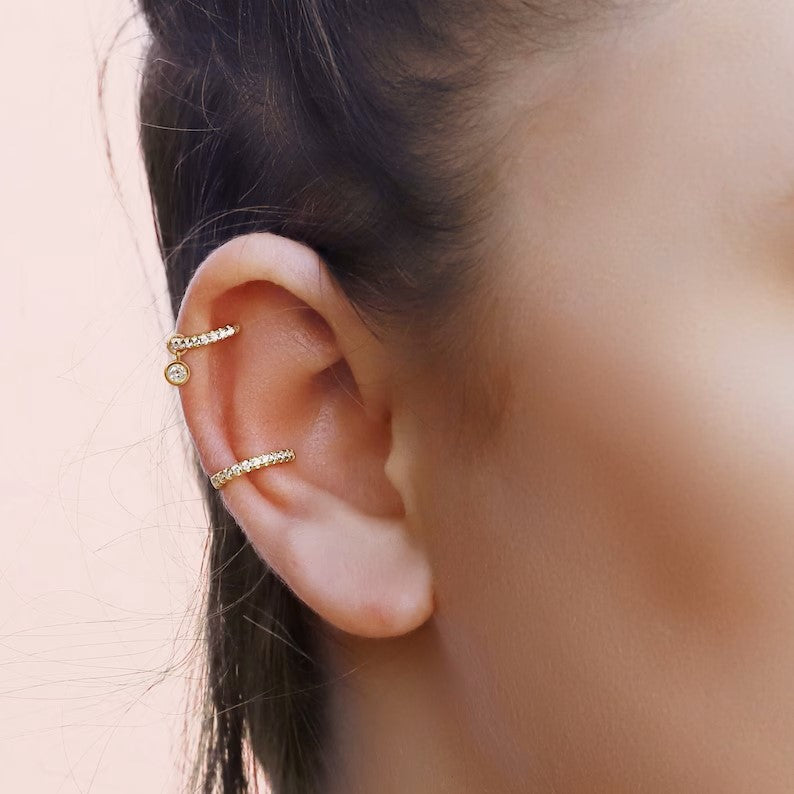 Gold conch and silver pave cartilage hoop earrings by AJJ, featuring small huggie and tragus hoops for cartilage and helix piercings.