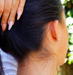 AJJ pearl huggie hoops featuring small, open silver hoop earrings with dainty design and elegant pearl accents.