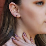 AJJ Poppy minimalist huggie hoops in silver, small open dainty hoop earrings displayed on a plain background.