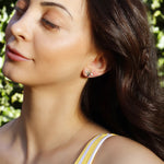 Silver stud earrings featuring a flying bee design by AJJ, inspired by summer bees, with detailed insect-shaped jewelry.