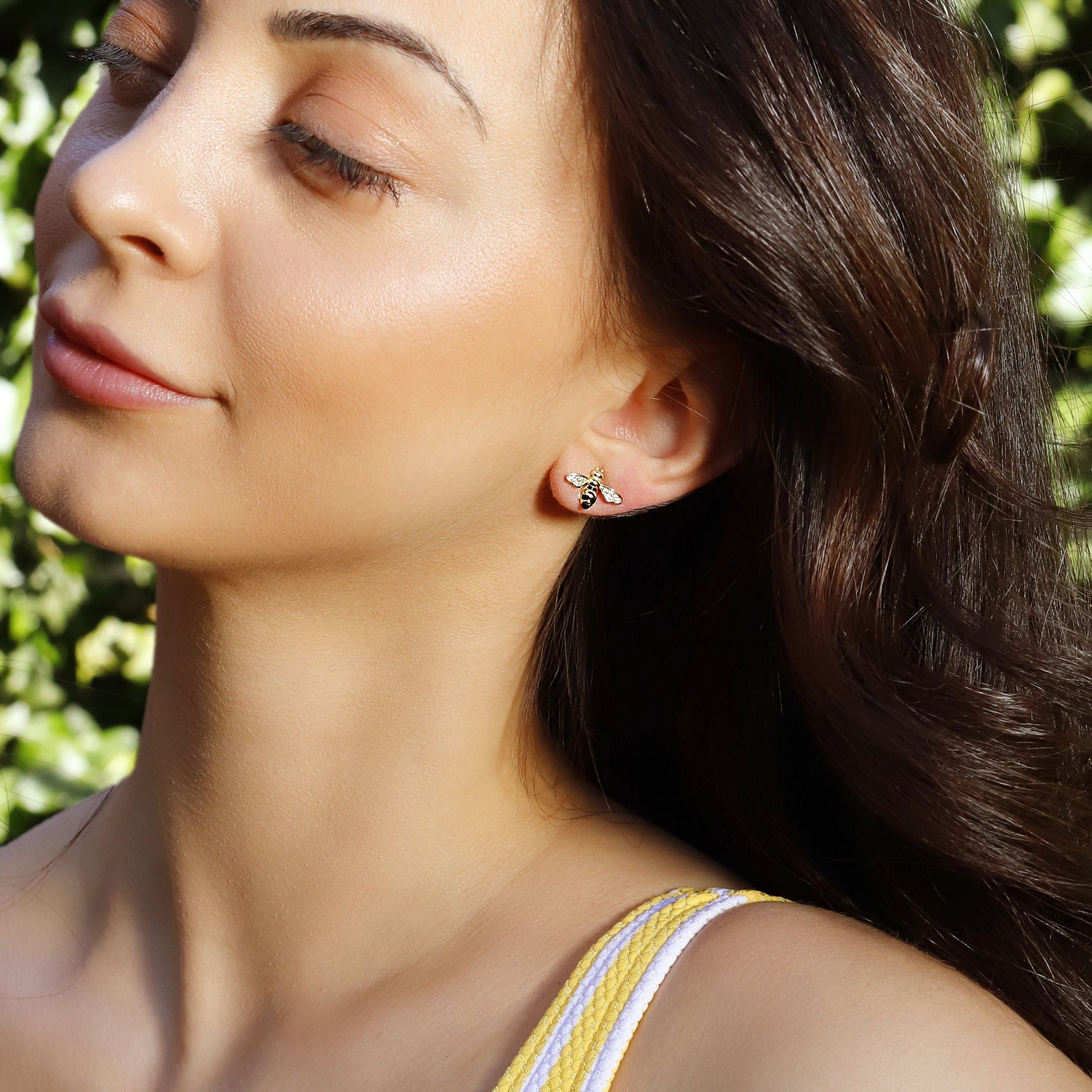Silver stud earrings featuring a flying bee design by AJJ, inspired by summer bees, with detailed insect-shaped jewelry.