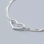 Silver heart charm bracelet for women featuring delicate love heart designs, perfect as a gift or stocking filler.
