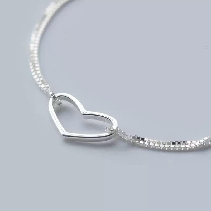 Silver heart charm bracelet for women featuring delicate love heart designs, perfect as a gift or stocking filler.
