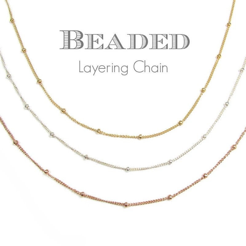 AJJ Niamh gold choker necklace featuring a delicate satellite chain design, close-up of the elegant satellite necklace on a model.