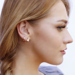 AJJ minimalist silver and gold huggie hoops, small solitaire dainty earrings with a sleek, modern design.