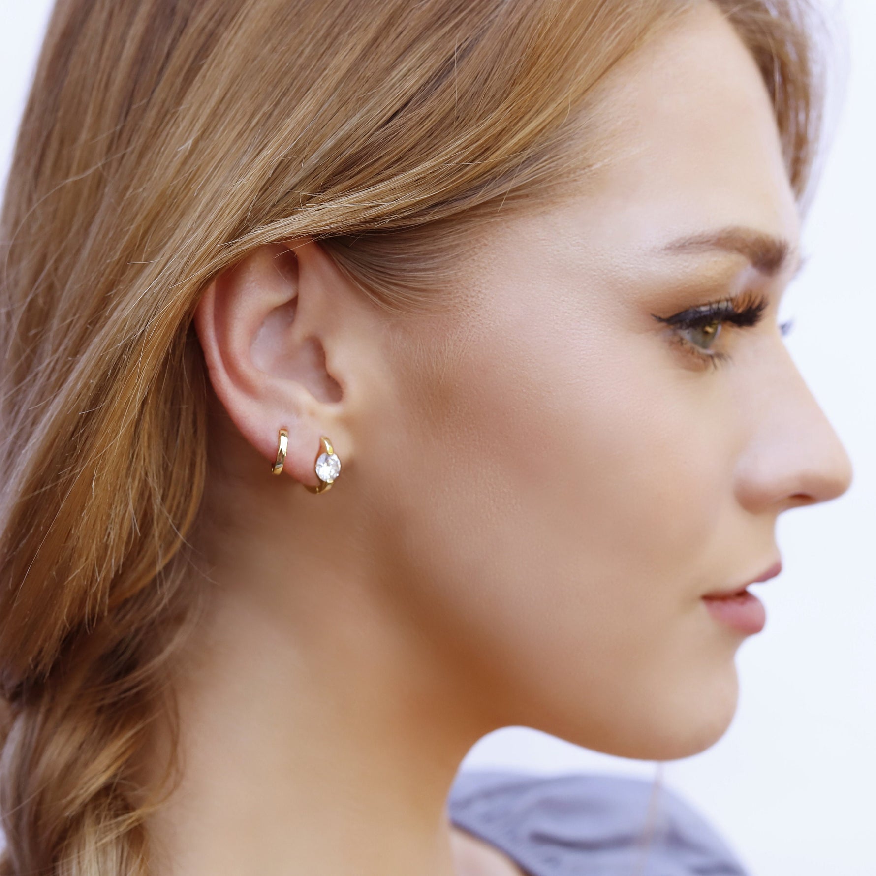 AJJ minimalist silver and gold huggie hoops, small solitaire dainty earrings with a sleek, modern design.