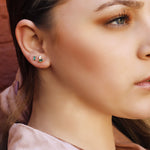 AJJ Heather tiny stud earrings with eye CZ diamonds, minimalist design, perfect for multiple piercings, showcasing a delicate jewelry style.