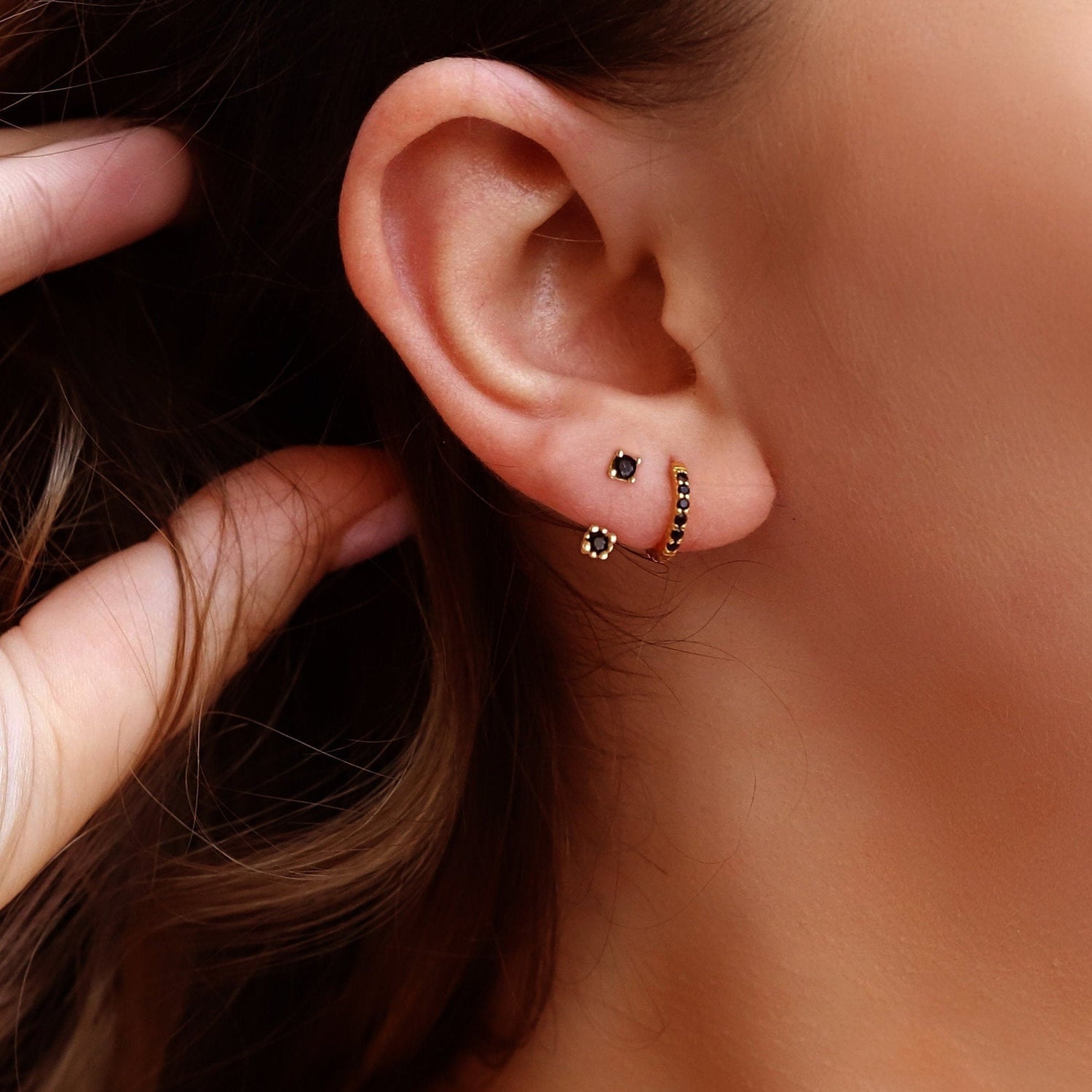Gold and silver Huggie Hoop Earrings by AJJ, cartilage and tragus hoops, featuring pave ring and small helix designs.
