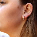 Silver AJJ minimalist huggie hoops with small pearl accents, dainty and elegant silver hoop earrings for everyday wear.