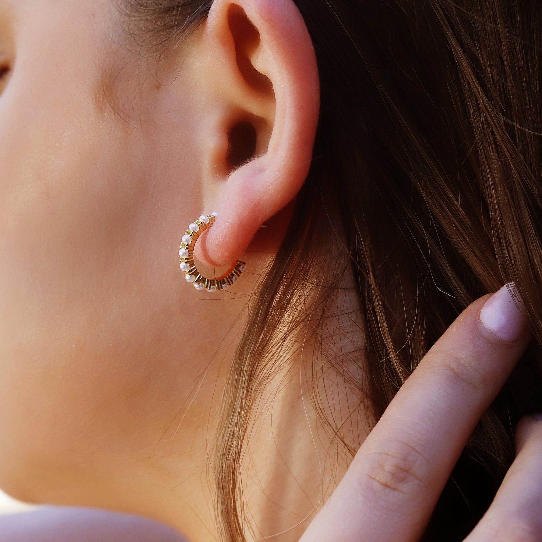 AJJ minimalist silver huggie hoops with small pearl accents, dainty and stylish hoop earrings for a subtle elegant look.