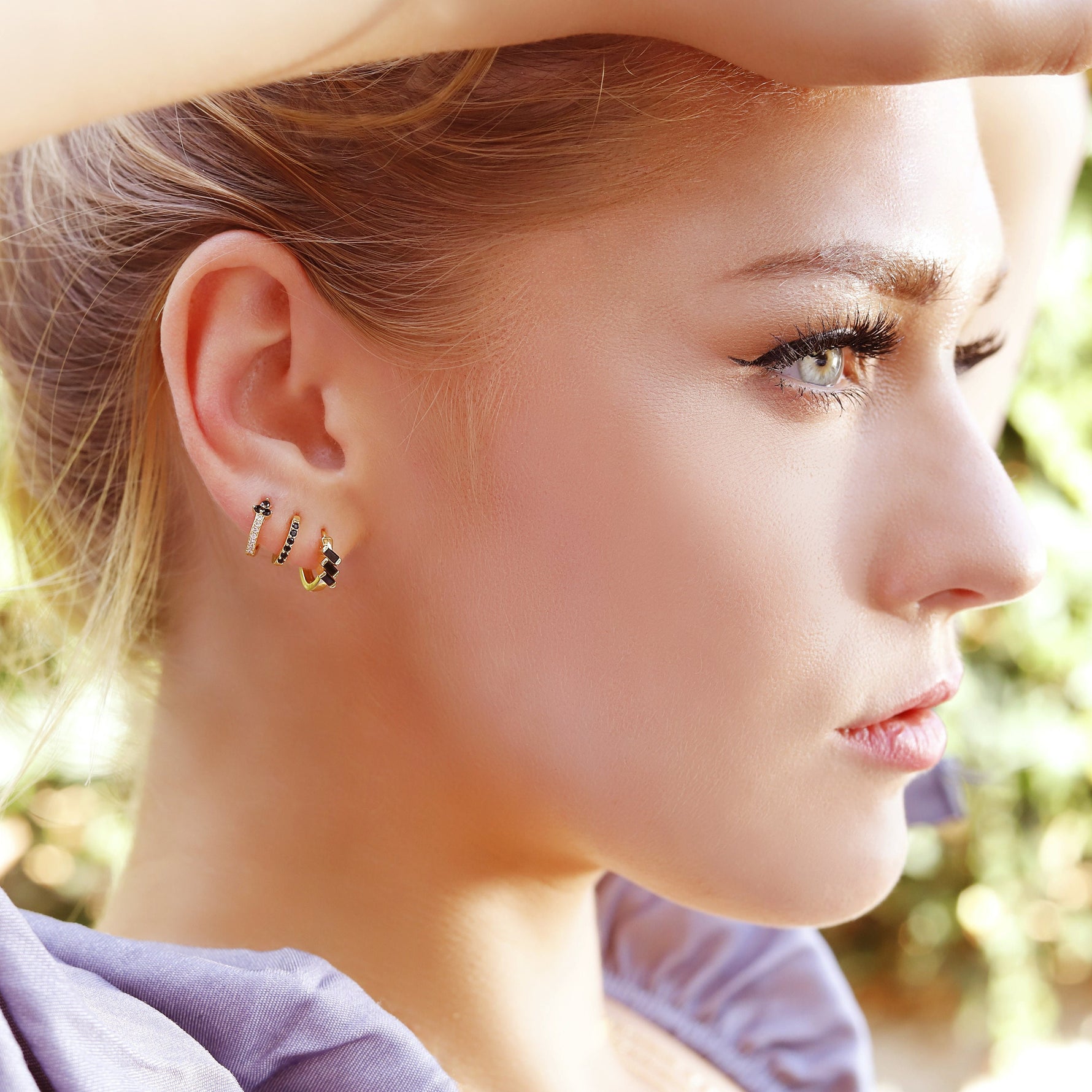 AJJ minimalist huggie hoops featuring small dainty silver and gold flower-shaped hoop earrings, perfect for everyday wear.