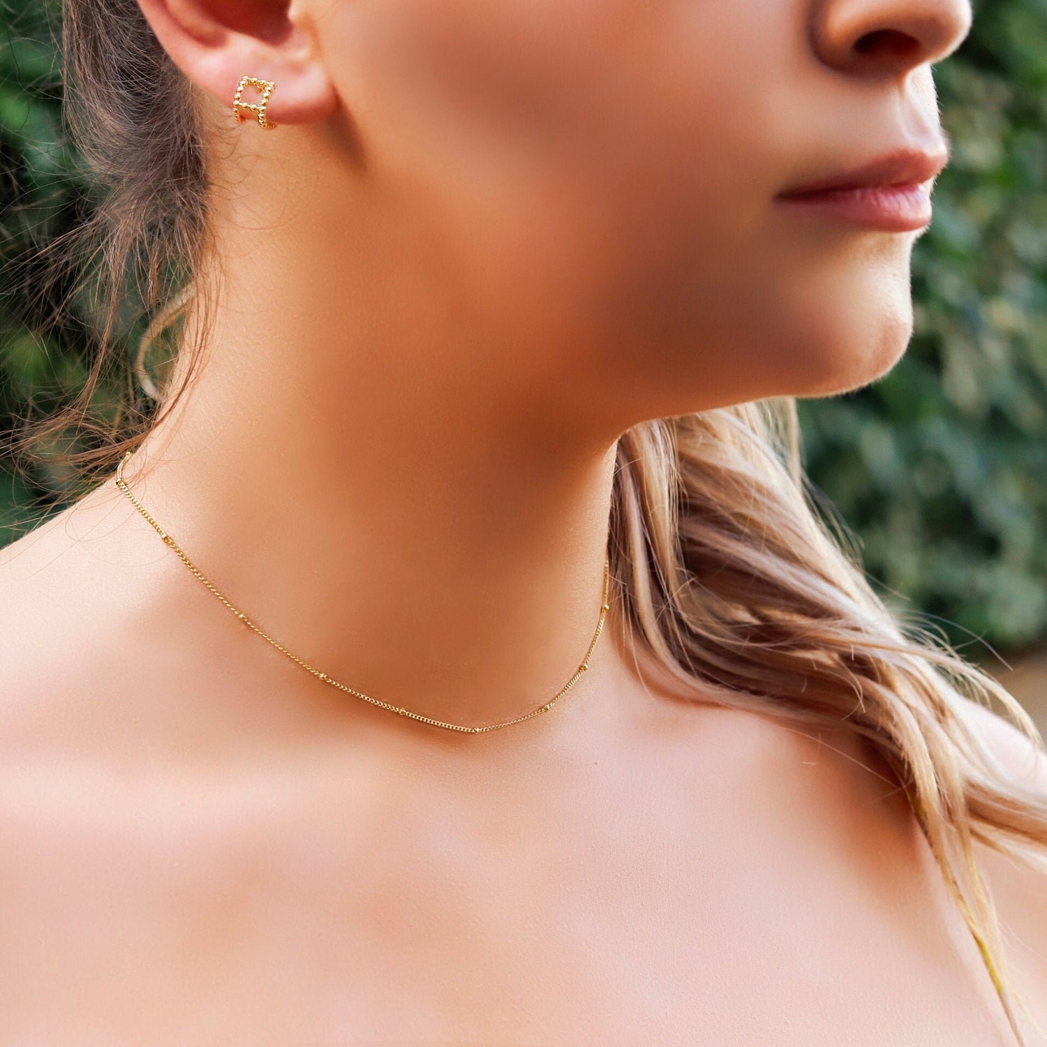 AJJ Niamh gold choker necklace featuring a delicate satellite chain design, close-up of the elegant jewelry piece.