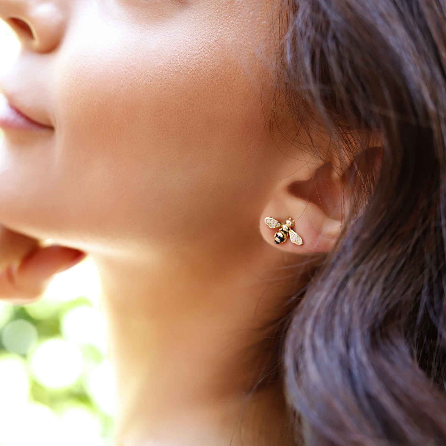 Silver stud earrings featuring a flying bee design, inspired by summer insects, crafted by AJJ.