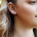 AJJ minimalist silver huggie earrings with pave bar design, small dainty lobe suspender earrings in a huggie style.