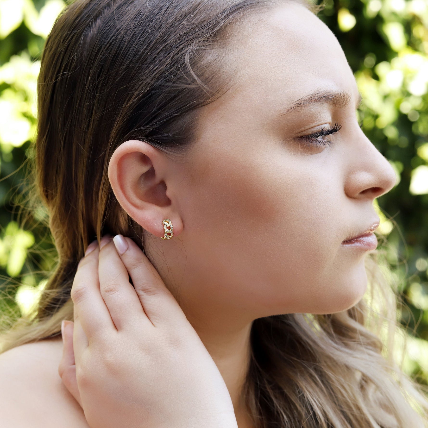 AJJ minimalist silver huggie hoops with small, chunky, dainty design, perfect for stylish everyday wear in a close-up image.