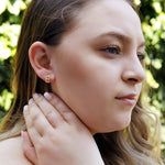 Silver AJJ minimalist huggie hoops, small and chunky dainty hoop earrings, close-up view of stylish silver hoop earrings