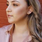 Silver and gold minimalist huggie hoops with dainty flower design, small club earrings, and elegant silver and gold huggie earrings.