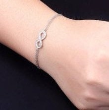 AJJ Sterling Silver Clementine bangle bracelet with infinity charm, adjustable for women, featuring a sleek and elegant design.