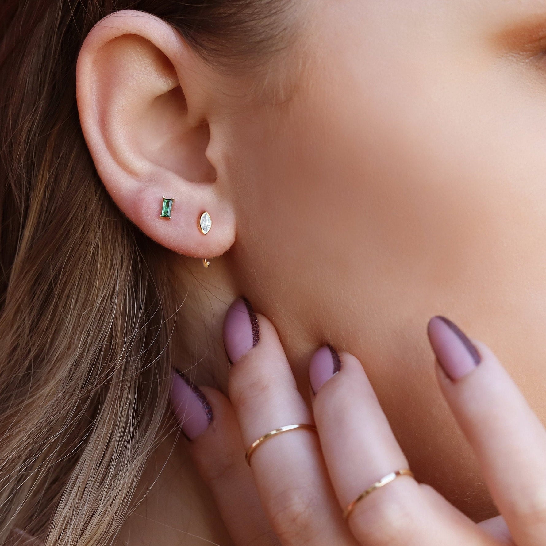 Sterling silver huggie hoop earrings by AJJ, delicate open geometric hoops, minimalist silver earrings with a sleek design.