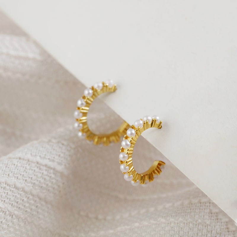 AJJ minimalist silver huggie hoop earrings with small pearl accents, dainty and stylish for everyday wear.