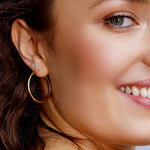 Pair of AJJ Sterling Silver 925 hoop sleeper earrings in various sizes, simple silver hoops on a white background.