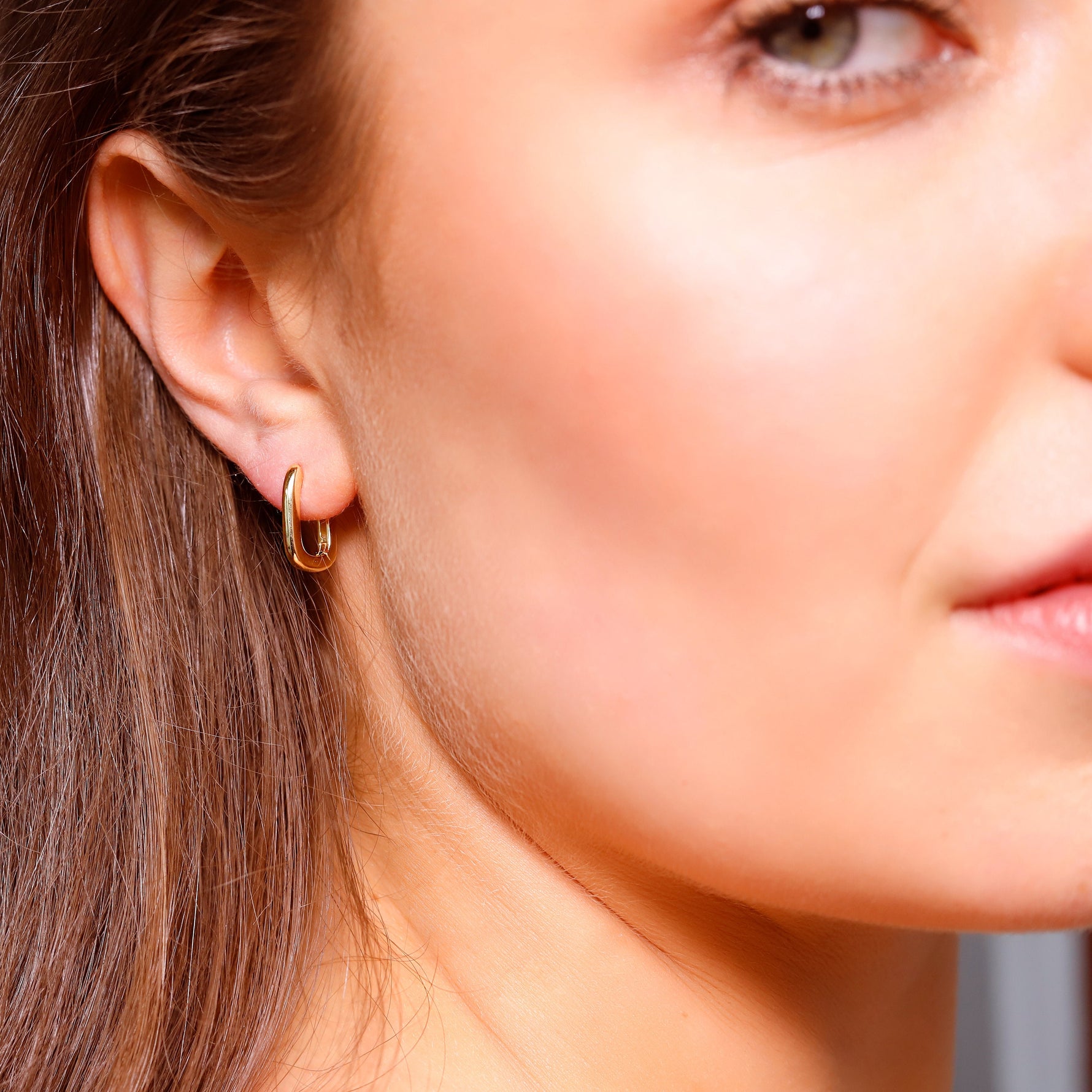 Small rectangular silver and gold huggie hoops with geometric design, dainty and stylish for everyday wear.
