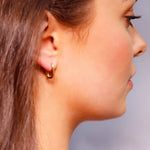 Small rectangular silver and gold huggie hoop earrings with geometric, dainty design, perfect for everyday wear.