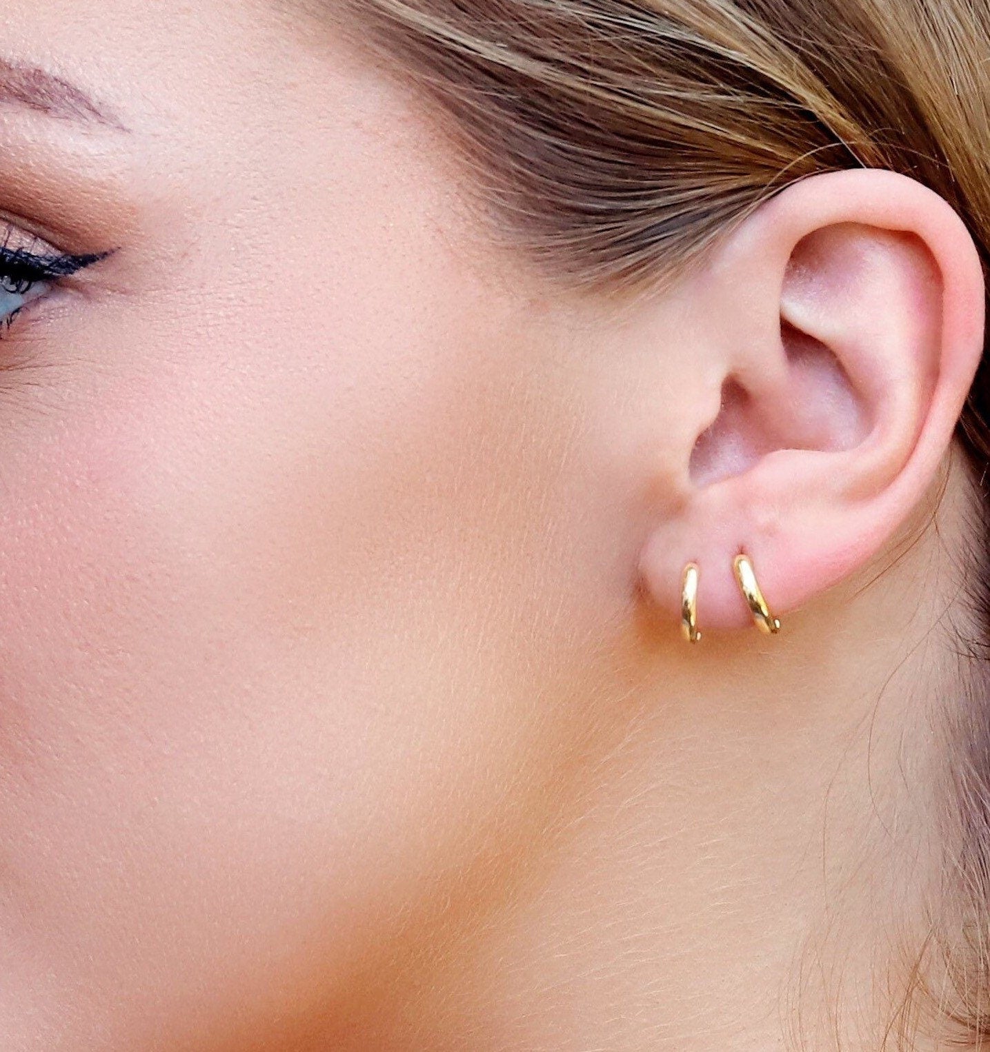 Sterling silver huggie hoop earrings by AJJ featuring delicate open geometric design and minimalist style.