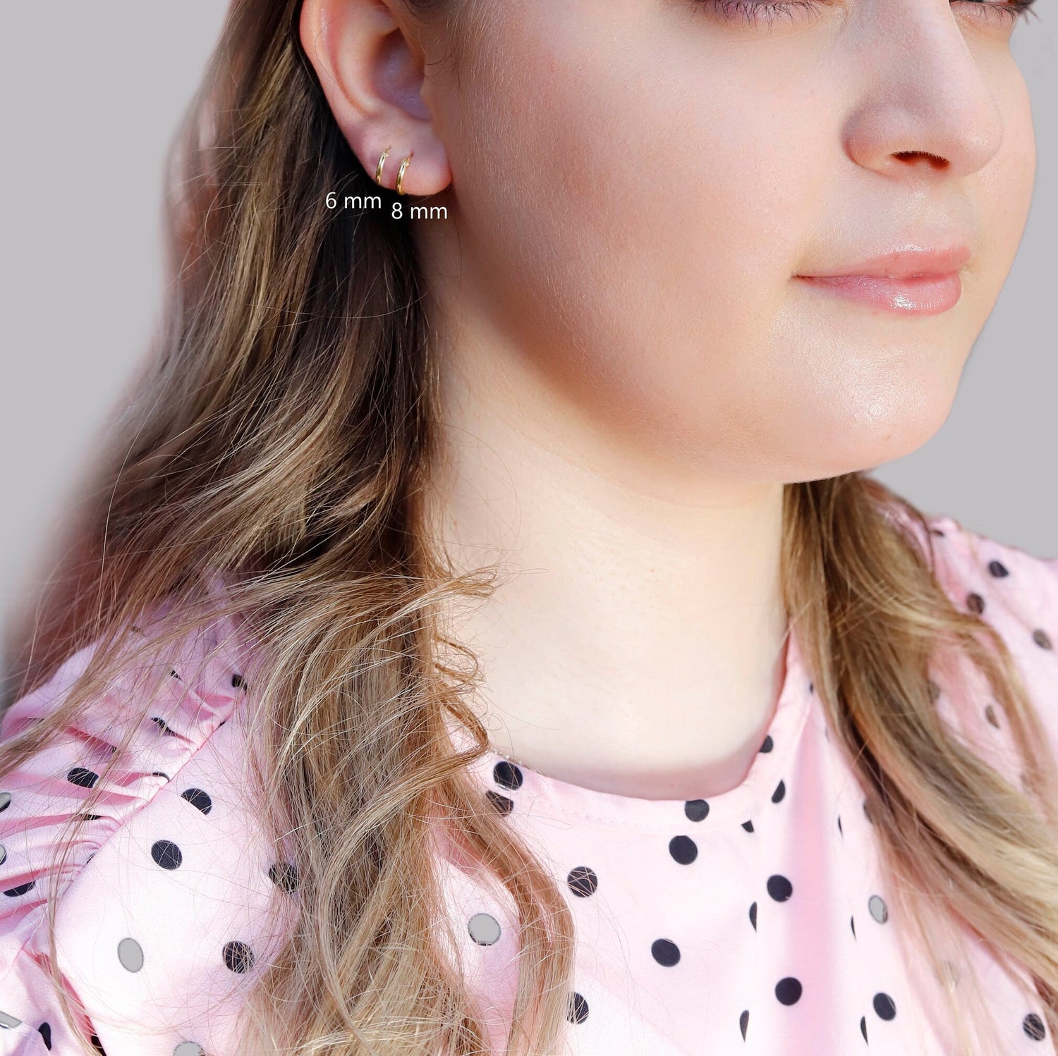 Small gold huggie hoop earrings set by AJJ, minimalist sterling silver hoops, classic size 8-30 mm, shown in close-up.