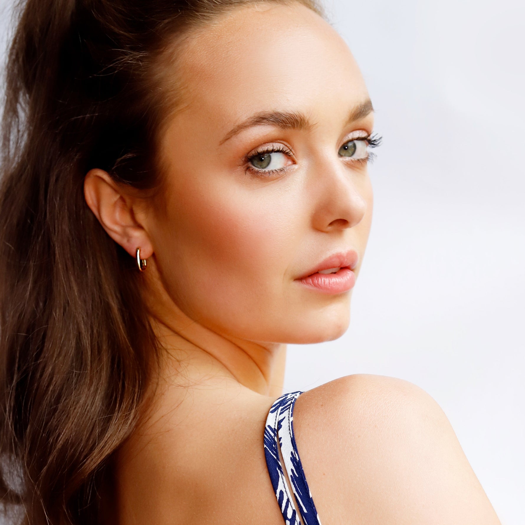 AJJ small rectangular silver and gold huggie hoop earrings with geometric, dainty design, perfect for everyday wear.