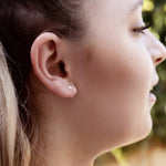 AJJ Pearl Huggie Hoops, small silver open hoop earrings with dainty pearl accents, designed for a subtle and elegant look.