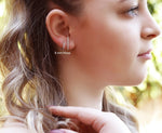 Silver AJJ minimalist lobe suspender huggie earrings with pave bar design, dainty tiny earrings for a subtle, stylish look.