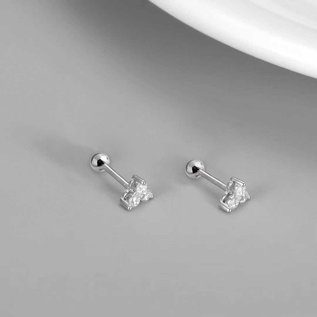 AJJ Tiny Stud Earrings set with round CZ studs, minimalist jewelry perfect for multiple piercings and everyday wear.