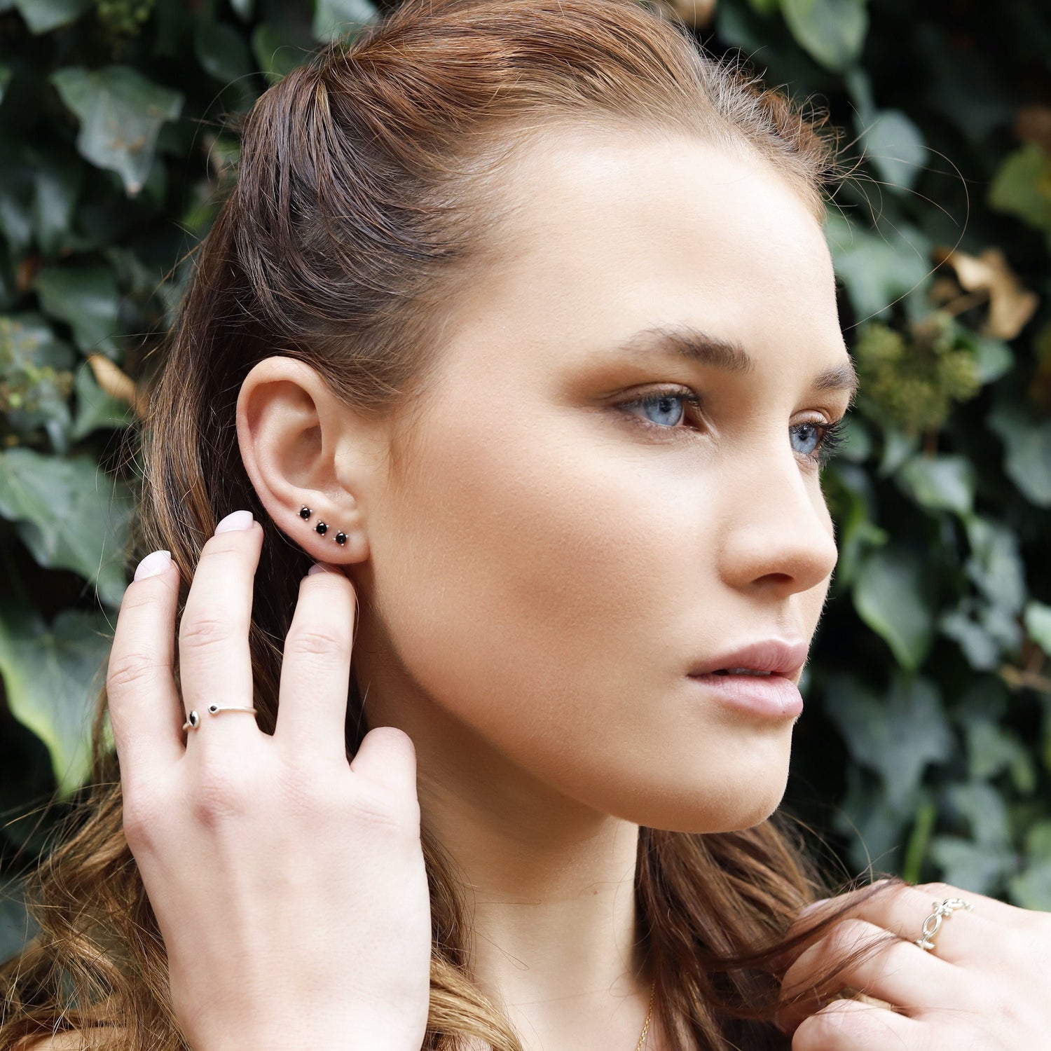 AJJ tiny round minimalist CZ stud earrings, perfect for multiple piercings, featuring small, shiny gemstone designs.