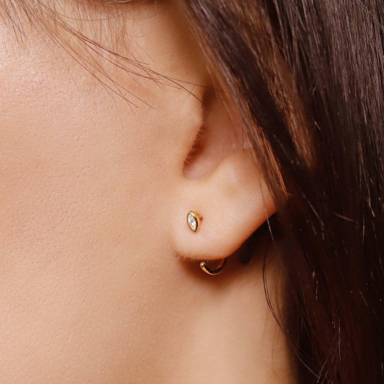 Sterling silver huggie hoop earrings by AJJ featuring delicate open geometric design, minimalist silver hoops for everyday wear
