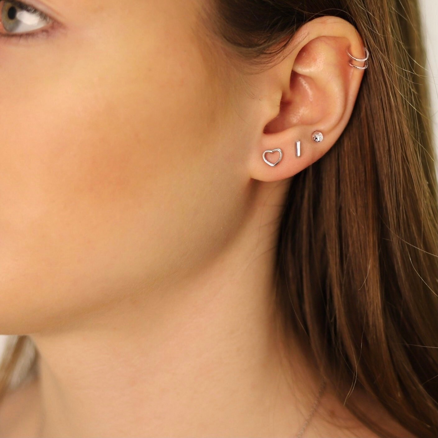 AJJ tiny silver heart stud earrings with dainty design, perfect small jewelry gift for women, moms, and friends.