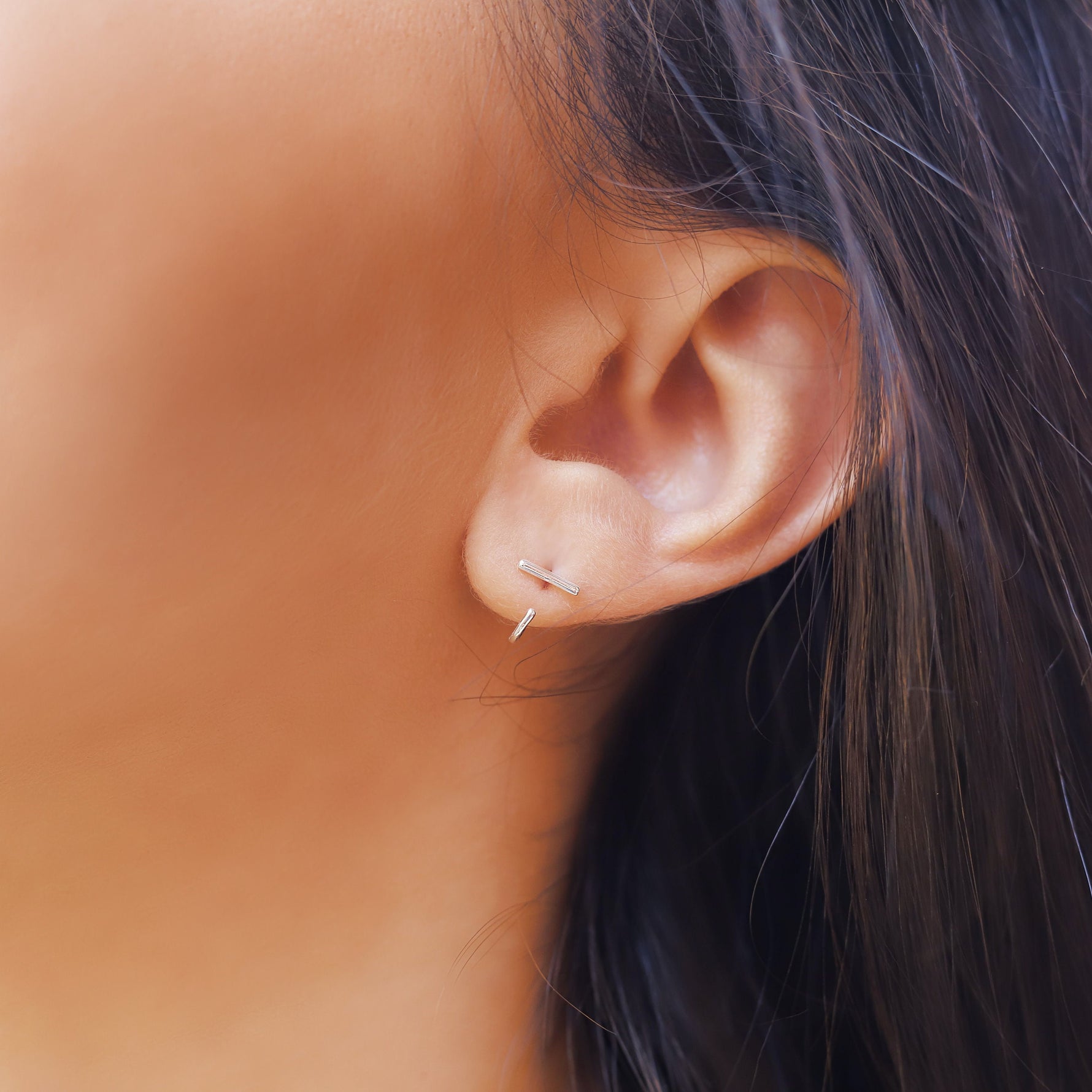 Small silver minimalist hoop earrings by AJJ, dainty open hoop jewelry with simple, sleek design for everyday wear.